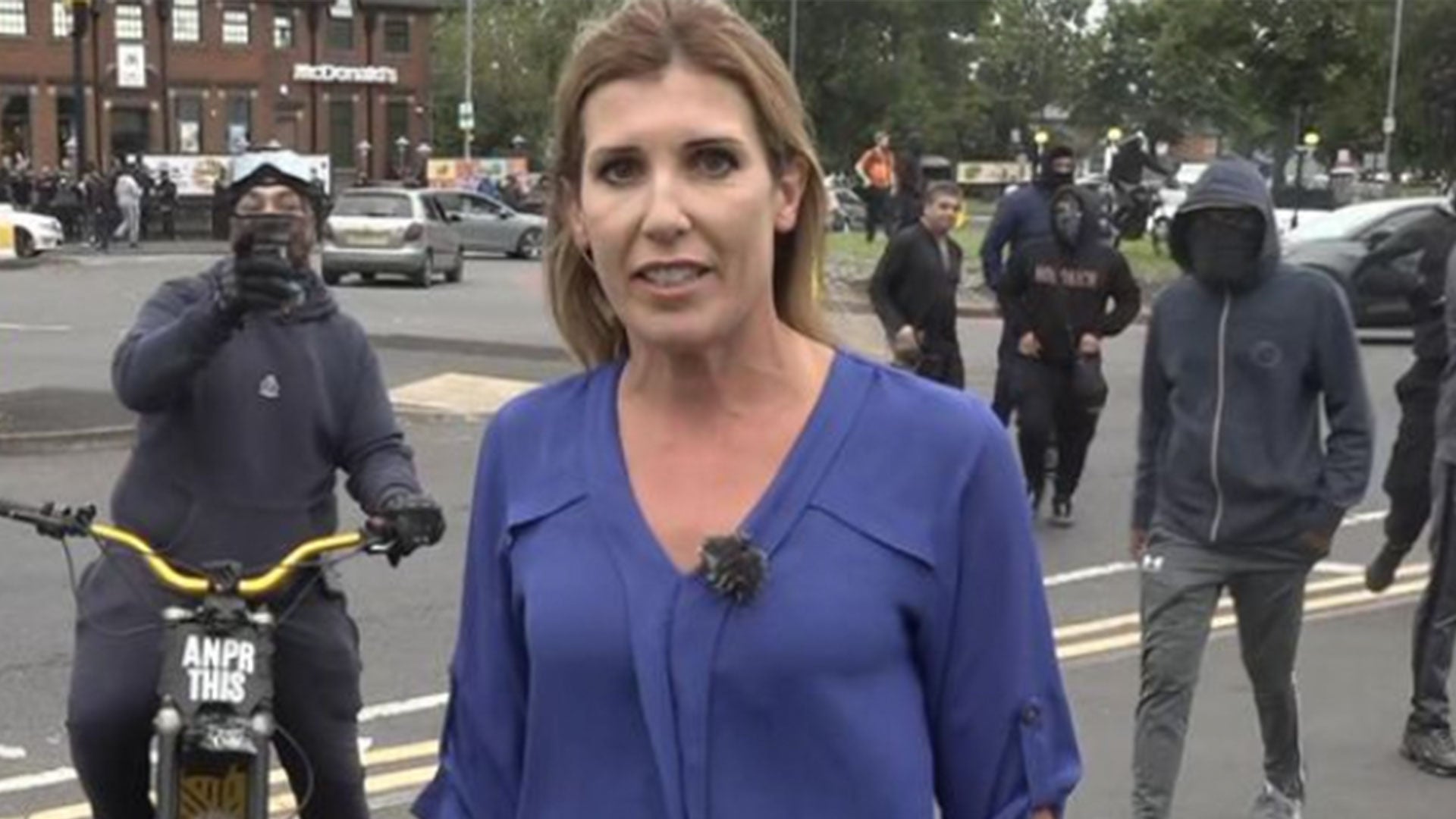 Sky reporter Becky Johnson was interrupted by a protester on a motorbike who swore and made rude gestures at the camera while attempting to deliver a live report in Birmingham